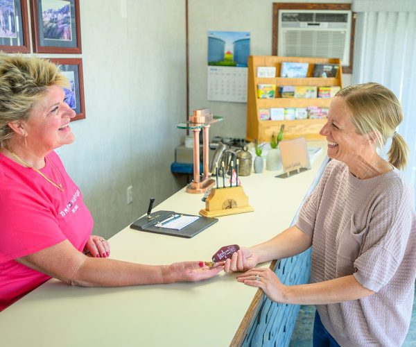 Smiling guest receiving key to room